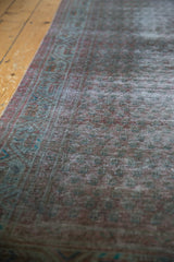 Distressed pile of vintage Persian Serbend runner with muted boteh motifs and geometric border.