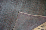 Distressed overdyed pile and woven hand-knotted foundation of a vintage Sparta runner.