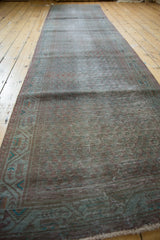 Distressed pile texture, overdyed muted tones, and geometric border on a vintage runner.