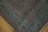 Distressed overdyed runner border in muted green and burgundy with vibrant teal accents.