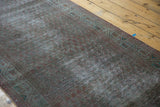 Subtle overdyed vintage runner with distressed pile and muted geometric border.