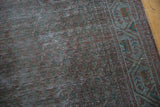 Distressed vintage runner with subtle overdyed green and brown tones, geometric border.