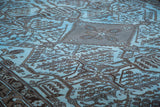 Vintage Afghani overdyed rug with dramatic charcoal and sky blue tribal geometric patterns.