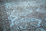 Charcoal geometric tribal patterns contrasted against dense sky blue on a vintage rug.