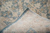 Hand-knotted foundation and distressed lattice pattern with sun-faded tones.