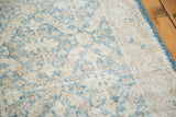 Distressed texture and sun-faded light green lattice motif of the vintage Turkish runner.
