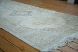 Blanched ivory distressed texture, subtle patterns, and fringe of this Sparta runner.