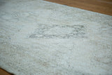 Detail of distressed Sparta runner's blanched ivory and charcoal lattice pattern.