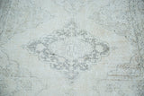 Blanched ivory, beige, charcoal lattice medallion on a distressed Sparta runner.