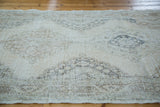Angled texture detail of a distressed Turkish Sparta runner with soft ivory and beige staggered medallions.