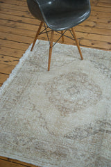 Distressed Sparta runner featuring one faded medallion, soft ivory and beige.