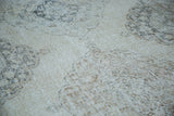 Distressed Sparta runner detail, showing soft ivory, beige, and coffee bronze faded medallion patterns.