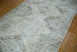 Close-up of distressed Sparta runner's Rococo medallions with scalloped character, ivory and beige tones.