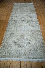 Distressed Sparta runner with faded Rococo medallions and fringe detail.