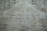 Distressed texture and scalloped Rococo medallion pattern in ivory and coffee bronze.