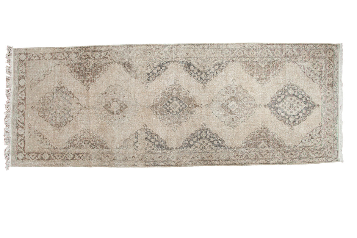 Distressed Turkish Sparta runner with soft ivory and muted coffee medallion patterns.
