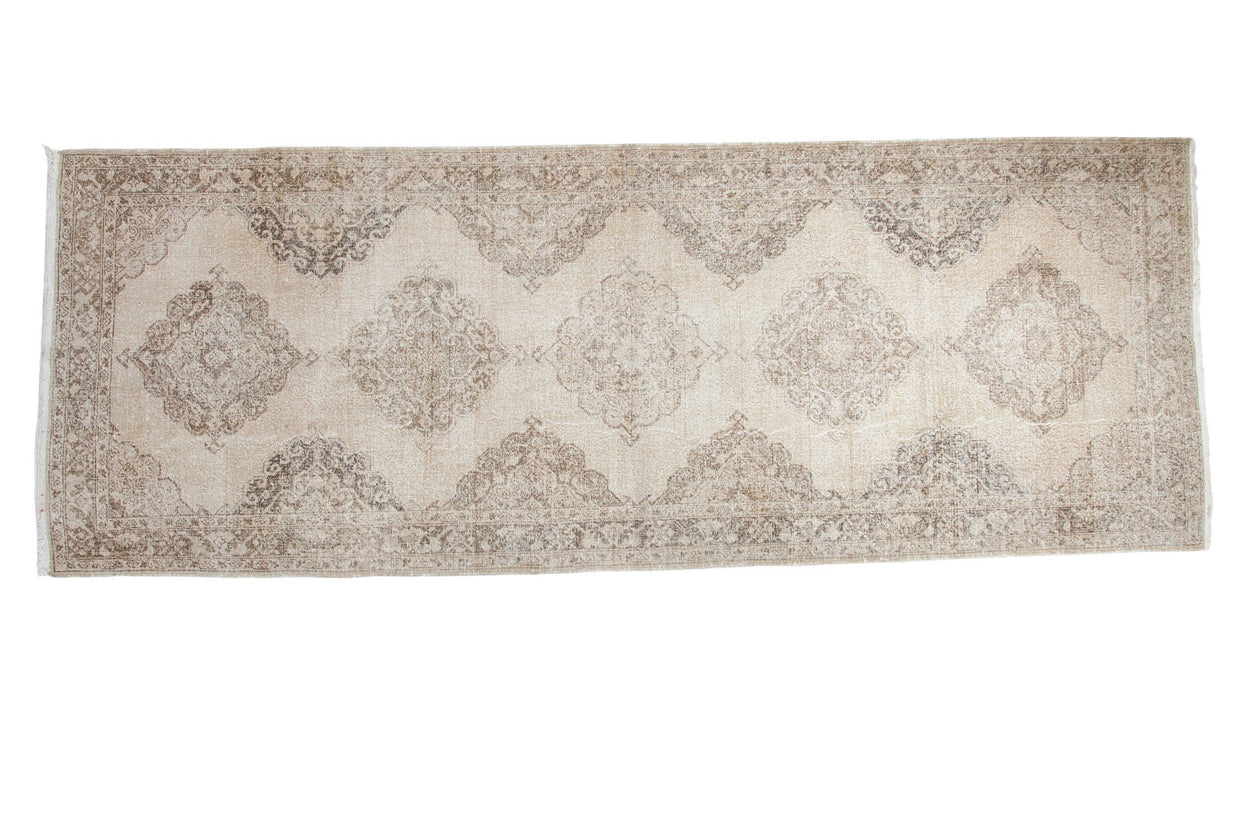 Hand knotted distressed Turkish Sparta runner, lattice medallion pattern in ivory and bronze.