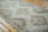 Decorative distressed Sparta runner showing muted ivory, beige, and bronze medallion patterns.