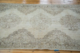Distressed Turkish Sparta runner featuring softened ivory, beige, and coffee bronze medallion patterns.