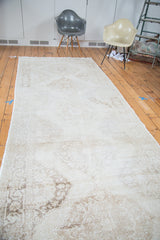 Faded ivory and coffee bronze lattice medallions on the distressed Turkish Sparta rug.