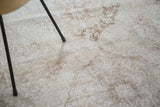 Hand knotted Turkish Sparta runner's distressed texture in soft ivory and coffee bronze.
