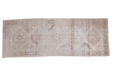 Distressed Turkish Sparta runner rug displaying faded ivory and beige quintuplet medallions.