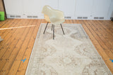 Distressed Sparta runner rug with repeated ivory, beige, and coffee bronze medallions.