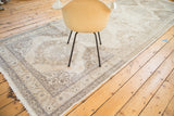 Distressed vintage Turkish Sparta runner, featuring muted ivory and beige medallions with leaf border.