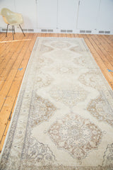 Distressed Turkish Sparta runner with faded ivory, beige, and coffee bronze medallions.