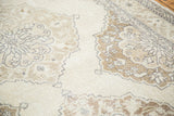 Distressed Sparta runner's flayed medallion and meandering border, soft ivory and coffee bronze tones.