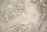 Distressed texture of a vintage Sparta runner, featuring soft ivory, beige, and faded pewter patterns.