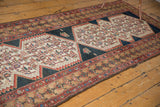 Aged multi-layered borders of a distressed Malayer runner.