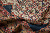 Distressed Malayer runner with stylized geometric motifs in navy, faded red, and beige.