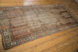 Distressed vintage Caucasian runner, highlighting faded geometric patterns in coffee, ivory, and tangerine.