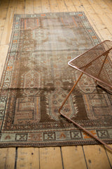Distressed geometric patterns in brown, beige, and tangerine orange at the Caucasian runner's corner.