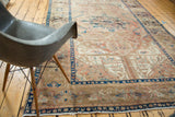 Vintage Kars carpet with dusty blush field, Heriz serrated leaves, and indigo border.