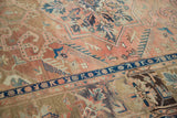 Hand-knotted Kars vintage carpet showing dusty blush field's Heriz design and indigo border.