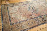 Vintage Kars carpet, dusty blush field with serrated leaves, scrolling vines, and indigo borders.