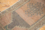 Vintage Oushak rug close-up: light peach field, faded teal and grey hook design.