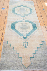 Vintage Oushak runner's stepped mallard green geometric border with grey and beige field.
