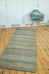 Vintage Kilim runner with horizontal stripes, geometric serpent patterns, and solid abrashes.