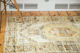 Vintage distressed Oushak rug with muted ivory and natural brown geometric designs.
