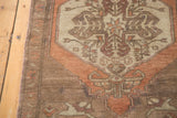 Plush wool pile of vintage Oushak rug, showing faded orange corner spandrel with floral details.