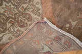 Hand-knotted reverse, fringe, and muted floral patterns of the vintage Turkish Oushak rug.