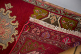Hand knotted reverse of vintage Oushak rug, showing geometric motifs and cream fringe.