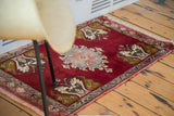 Cherry red vintage Turkish Oushak rug showing a germinating tree motif and patterned border.