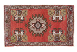 Vintage Oushak rug mat: cinnabar red field, dramatic grey and bronze medallion, germinating tree motifs.
