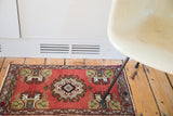 Germinating tree and planter design on the vintage Oushak rug's cinnabar red field.