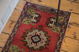 Geometric germinating tree design with sage green and brown on a cinnabar red Oushak rug.
