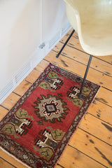 Vintage Oushak rug detail: cinnabar red field, germinating tree motif, and grey medallion.